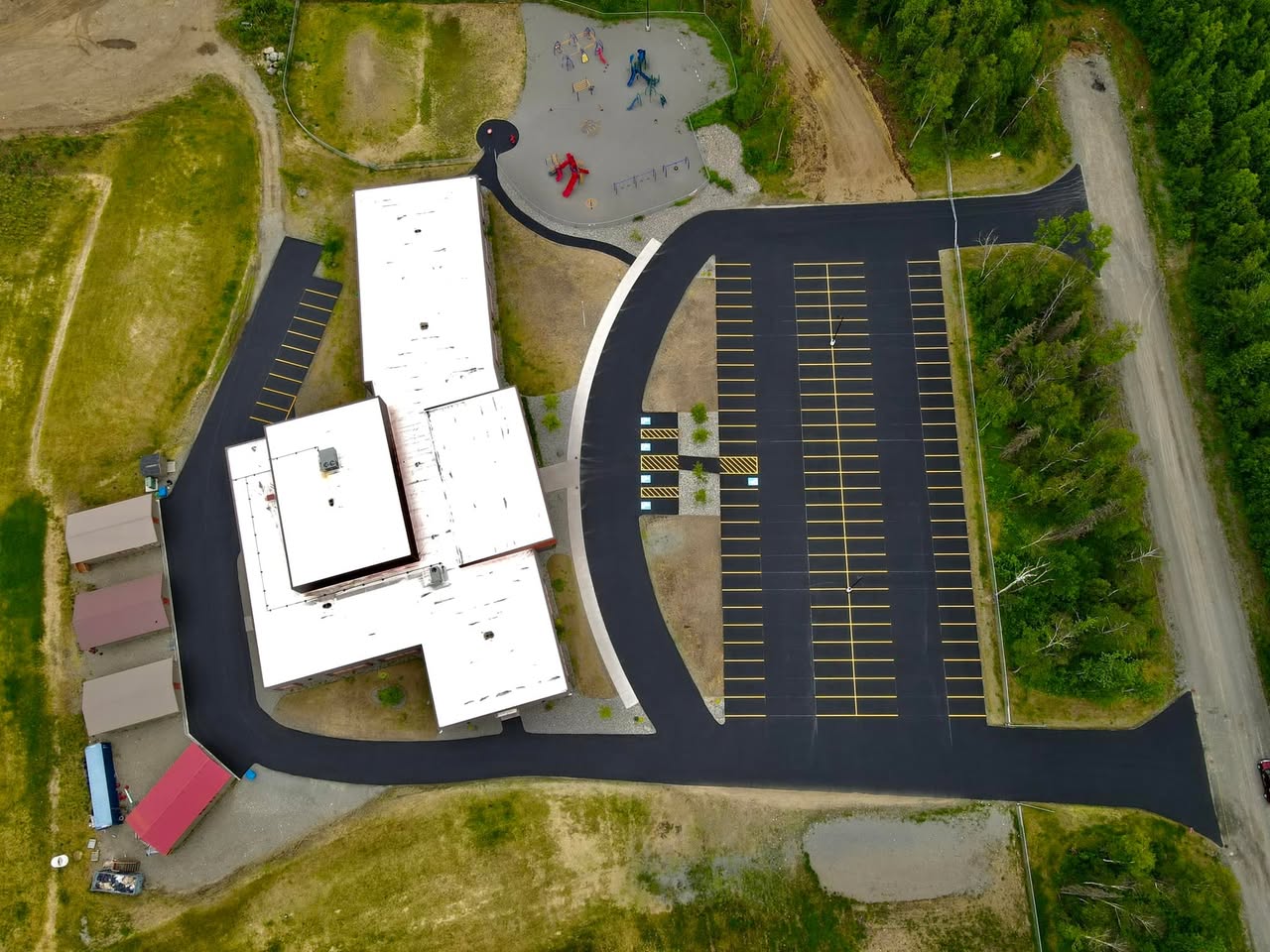 Aerial view of a freshly sealcoated school parking lot in Southwest Montana.
