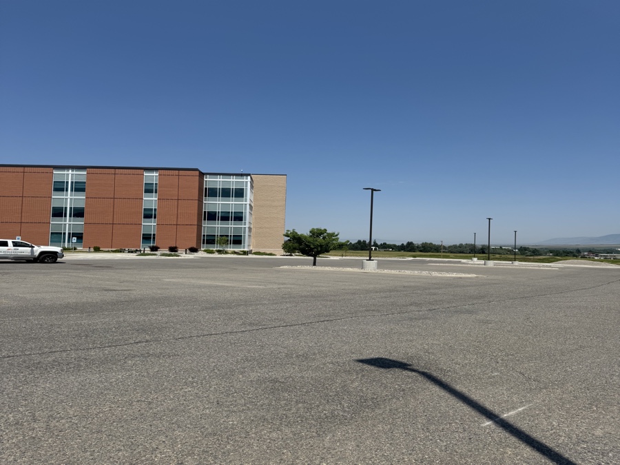 Commercial parking lot shown before and after professional sealcoating and striping