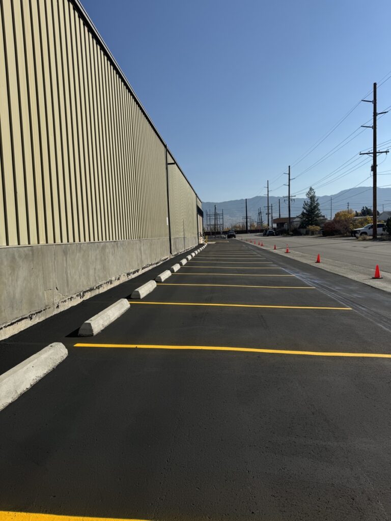 Commercial parking lot shown before and after professional sealcoating and striping
