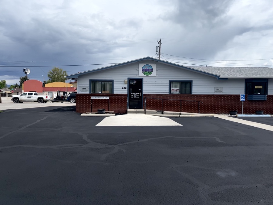 Before and after photos of a retail center parking lot sealcoating project