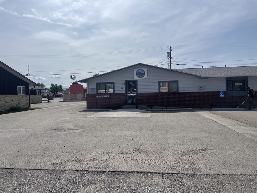 Before and after photos of a retail center parking lot sealcoating project