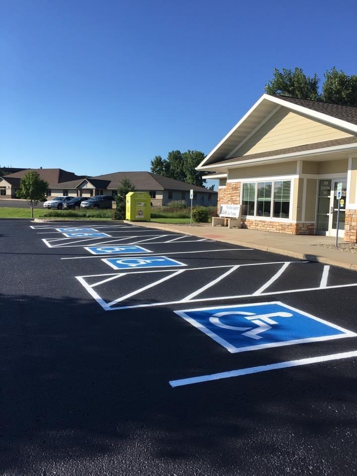 Freshly sealed asphalt with clearly marked handicap parking designation in Southwest Montana.